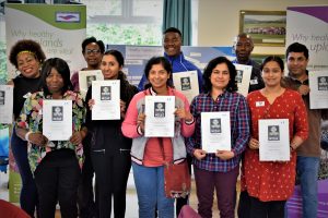 Community Champions from 2017 standing with their certificates
